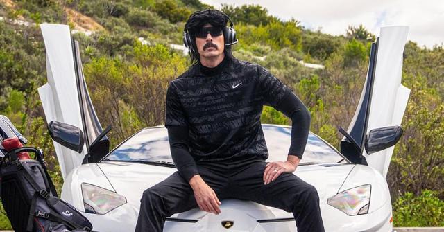 Dr DisRespect sits on the hood of a white car