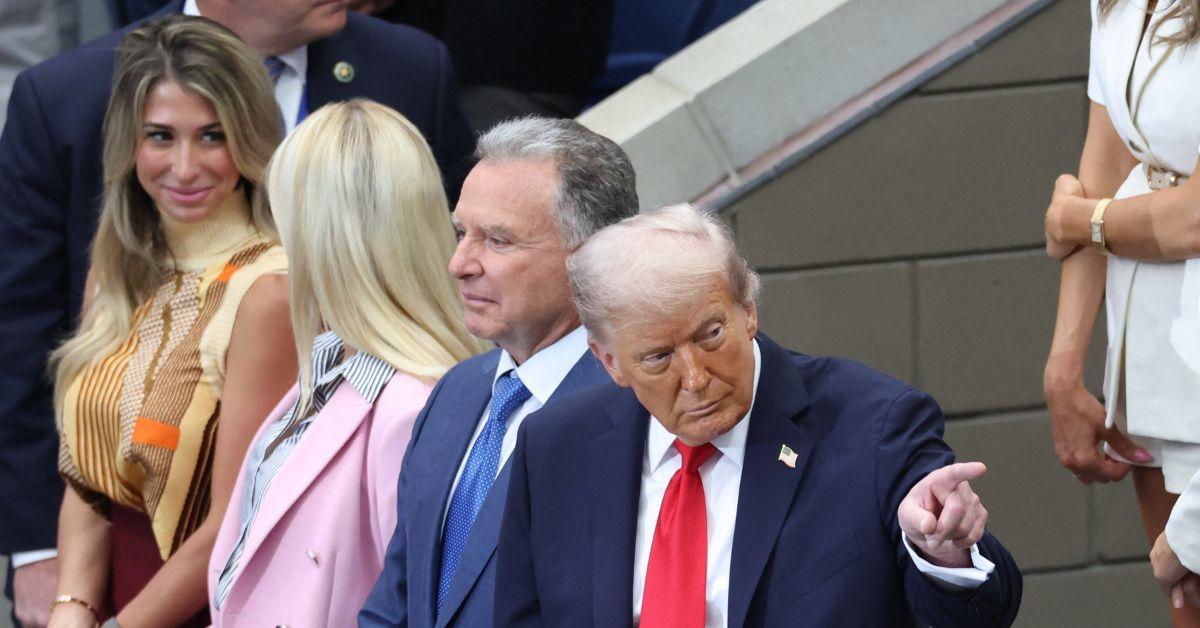 Donald Trump pointing while attending the U.S. Open. 