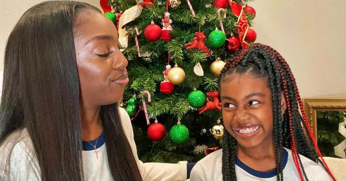 Da'Vonne Rogers with her daughter in front of a Christmas tree