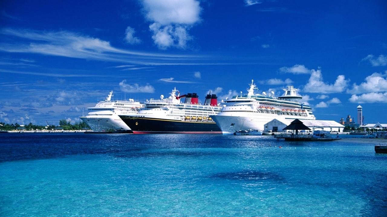 Three cruise ships docked in a port