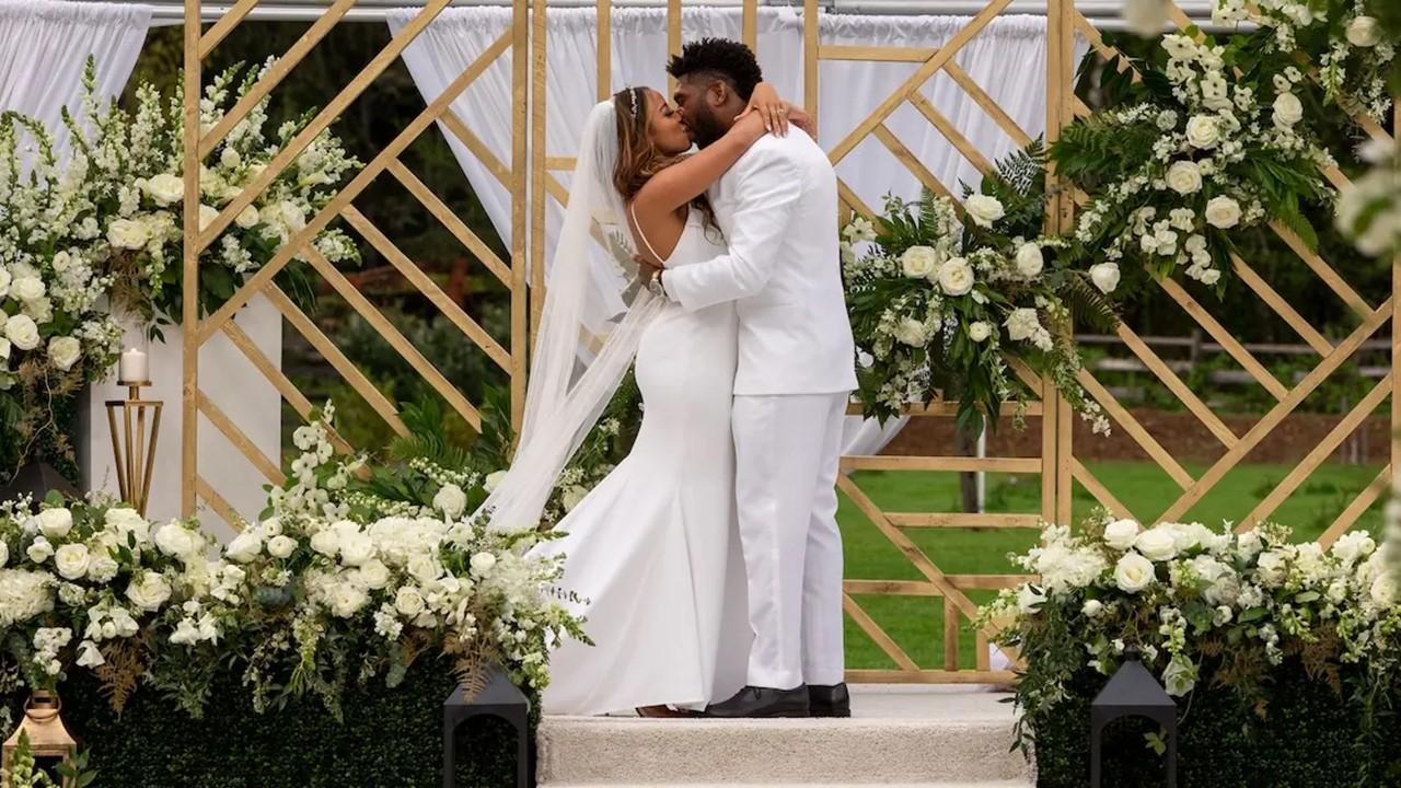 Tiffany and Brett Brown kissing at the altar during their wedding.