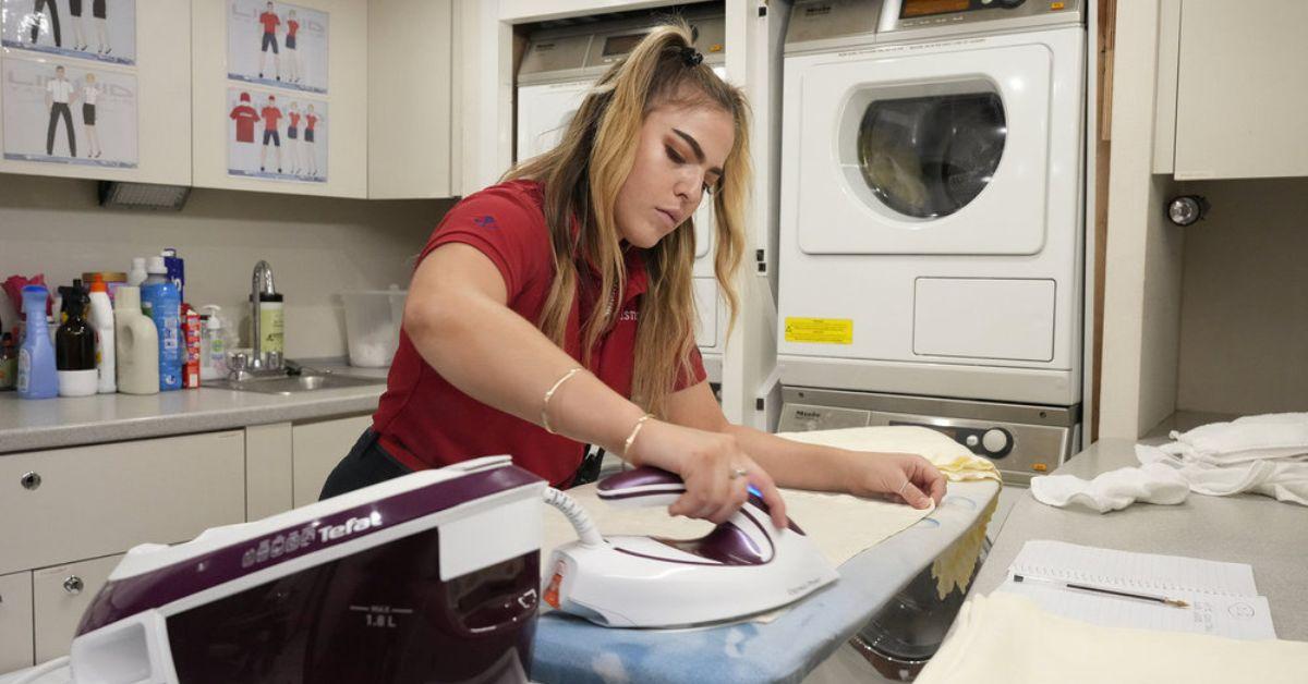 Bri Muller ironing in the laundry room of The Mustique