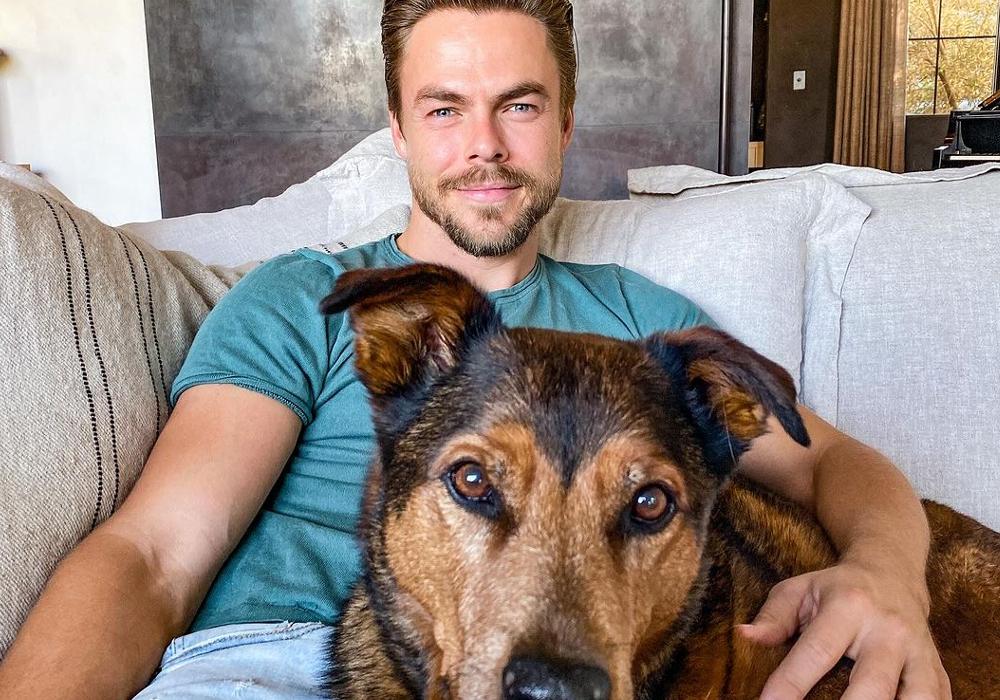 Derek Hough and one of his dogs on the couch