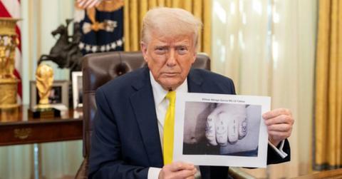 Donald Trump holding a doctored photo of Kilmar Abrego Garcia's hand.
