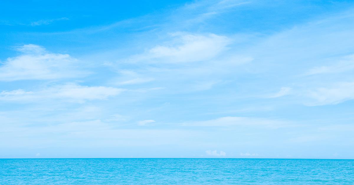 A horizon with water and blue sky above it. 