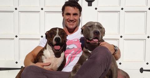Greg Plitt posing with two dogs