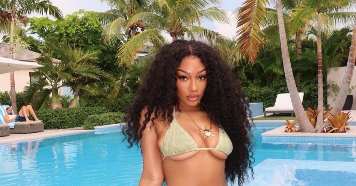 (l-r): Klay Thompson and Megan Thee Stallion poolside.