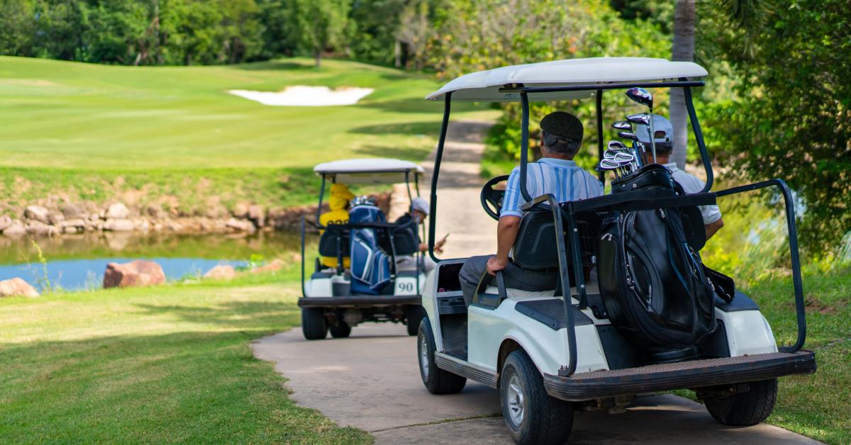 A group of guys in golf carts.