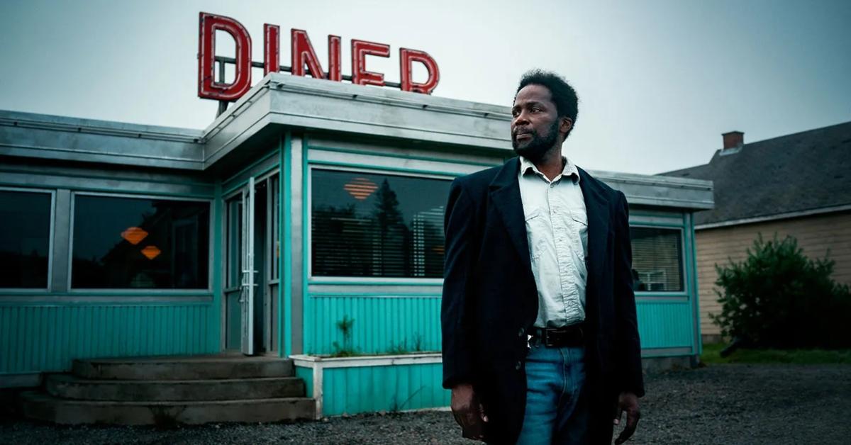 Boyd stands in front of the motel on FROM