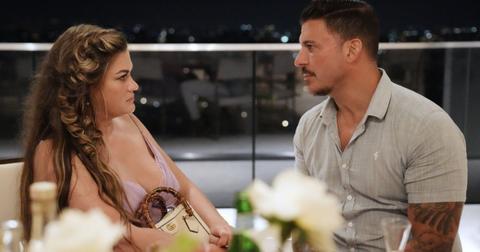 Brittany Cartwright and Jax Taylor seated at a table and talking