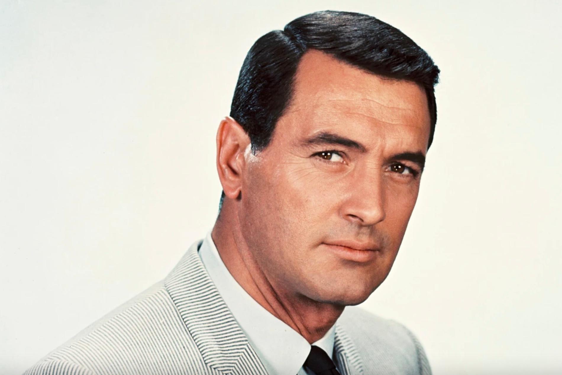 Rock Hudson wearing a striped suit in 1960.