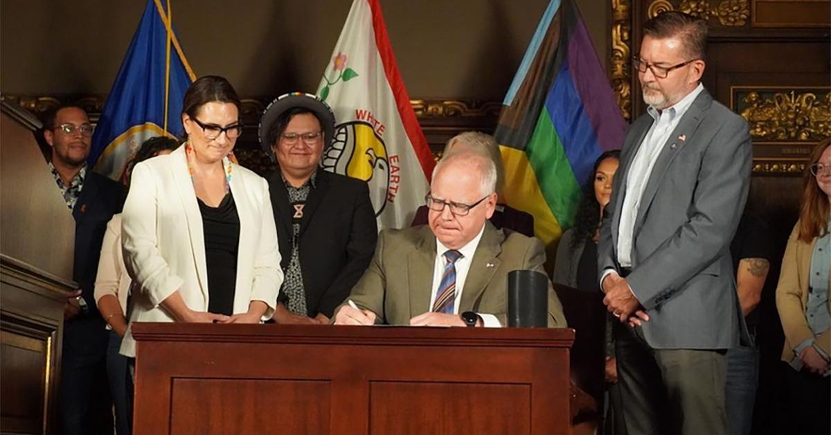 Tim Walz (center) signs a bill banning conversion therapy in Minnesota in 2023