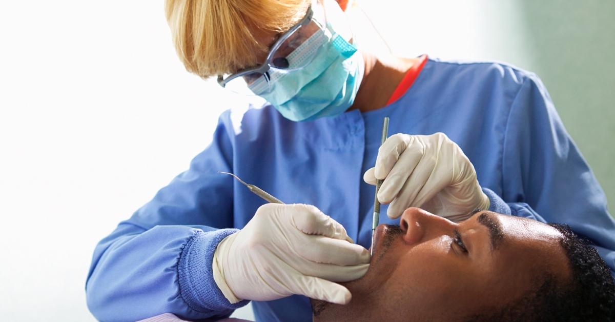 A dental hygienist cleaning a patient's teeth