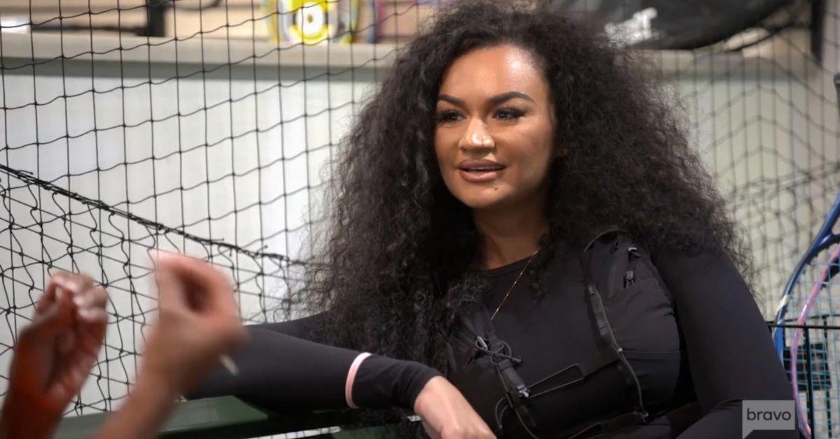 Kenya's friend, Akilah, listening to Kenya while their daughters play tennis