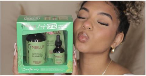 A woman holding Mielle Organics