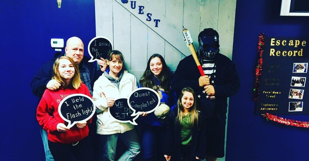 Shauna Rae and her family posing together at an escape room. 