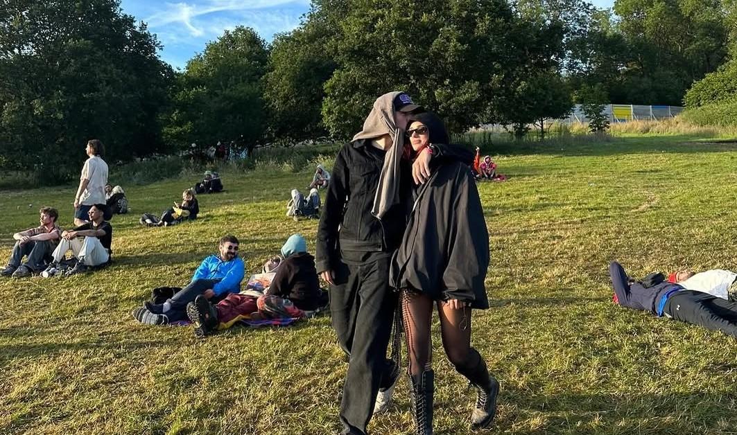 Callum Turner kissing Dua Lipa's head while walking 