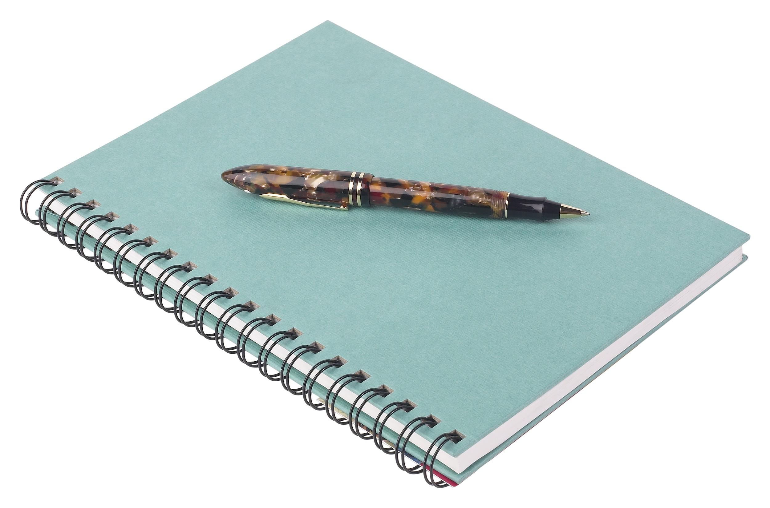 A spiral hardcover notebook in turquoise with pen