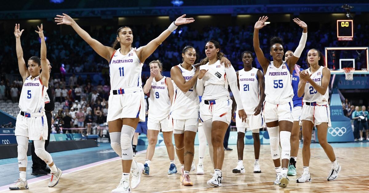 Puerto Rico's #11 Sofia Roma and Puerto Rico's players acknowledge the public at the end of the women's preliminary round group A basketball match between Puerto Rico and Spain during the Paris 2024 Olympic Games at the Pierre-Mauroy stadium in Villeneuve-d'Ascq, northern France, on July 31, 2024. (Photo by Sameer Al-Doumy / AFP) (Photo by SAMEER AL-DOUMY/AFP via Getty Images)