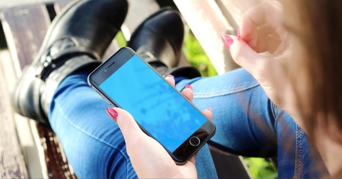 A woman uses her iPhone.