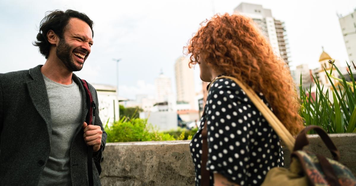 man and woman talking and laughing outside