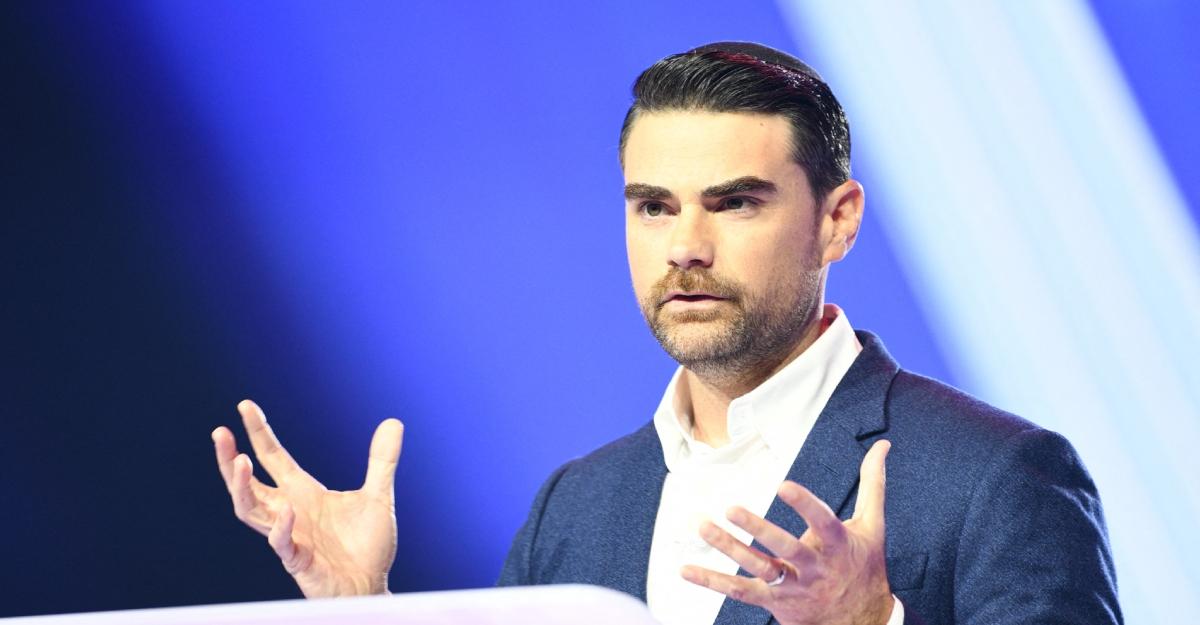 Ben Shapiro speaks at a podium at AmericaFest 2025.