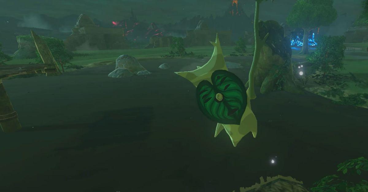 A Korok flying on a petal above a lake in Breath of the Wild.