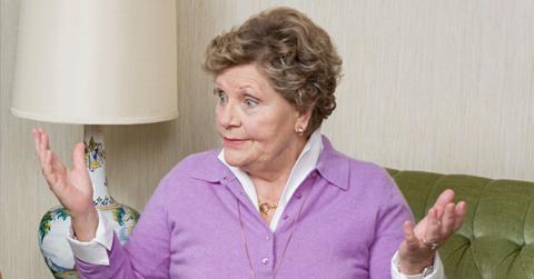 Elderly white woman shrugs her shoulders.