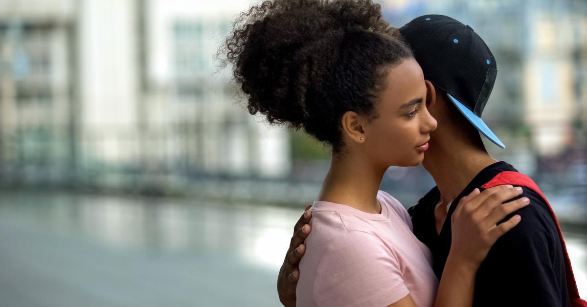 Teen couple of teenagers hugging during outdoor date