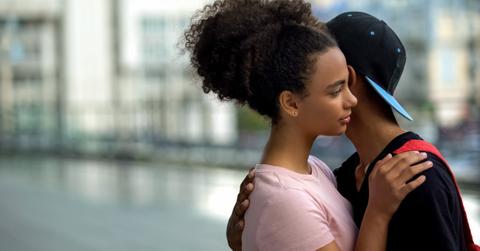 Teen couple of teenagers hugging during outdoor date