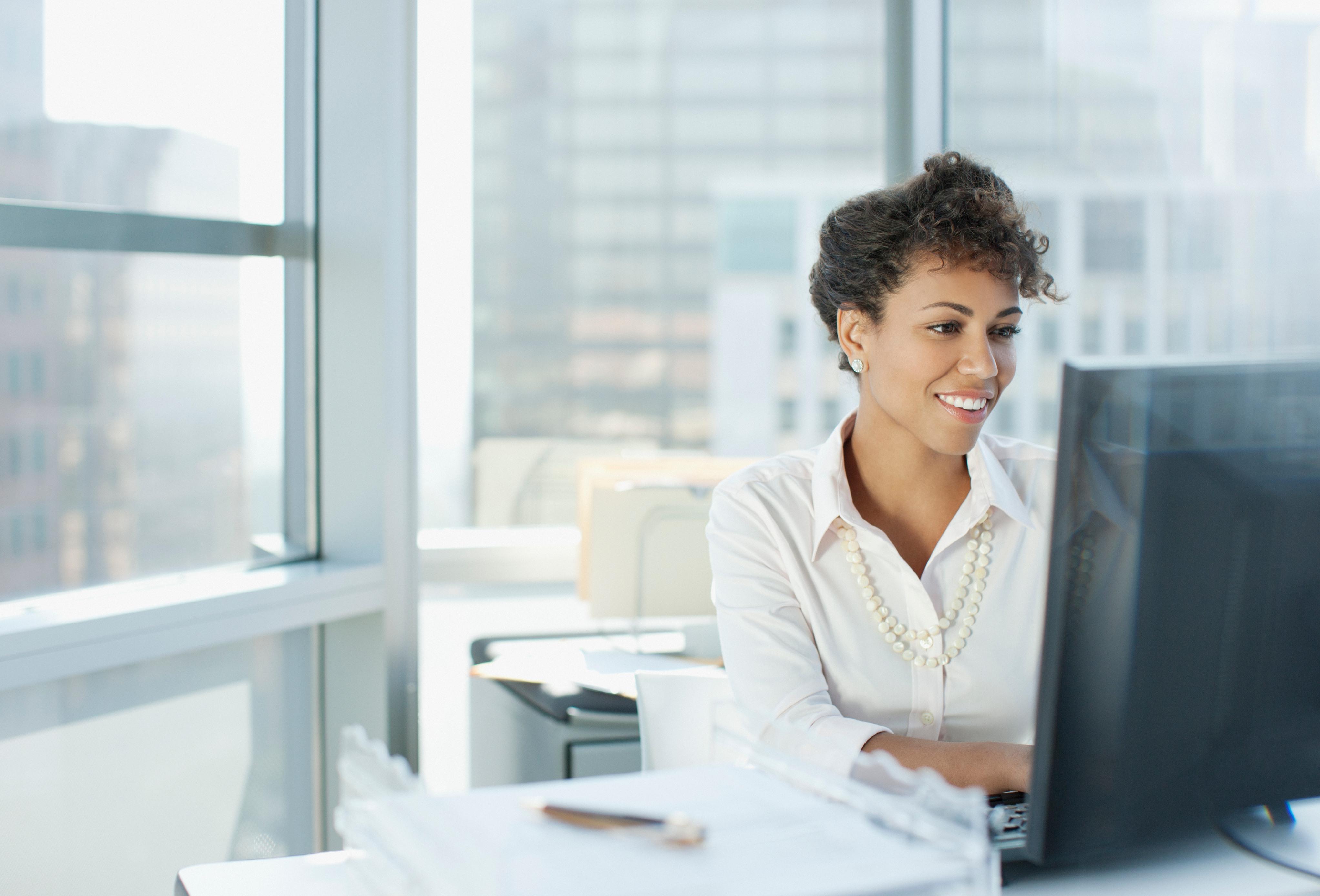 Businesswoman working at desk in an office.