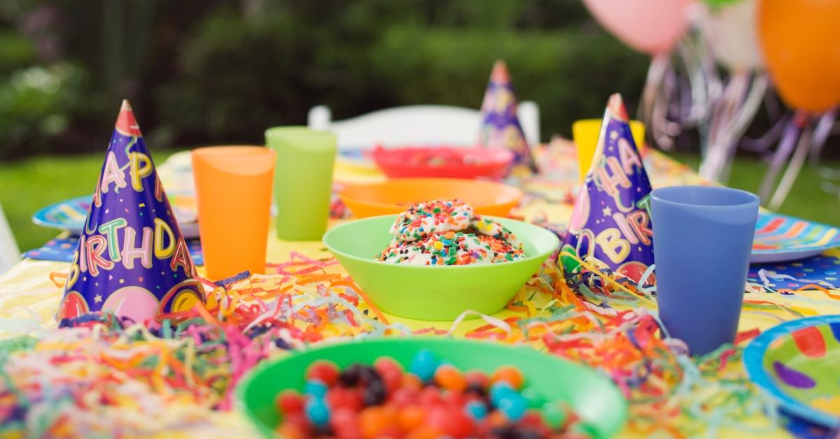 birthday table outdoors hats drinks food balloons