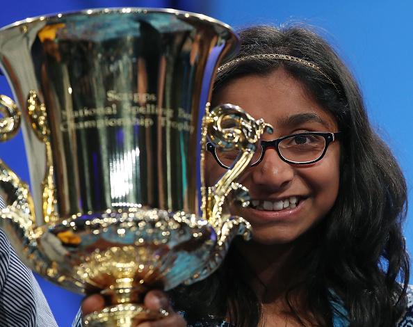 12 year old Ananya Vinay of Fresno, CA. holds her trophy after winning the 2017 Scripps National Spelling Bee 