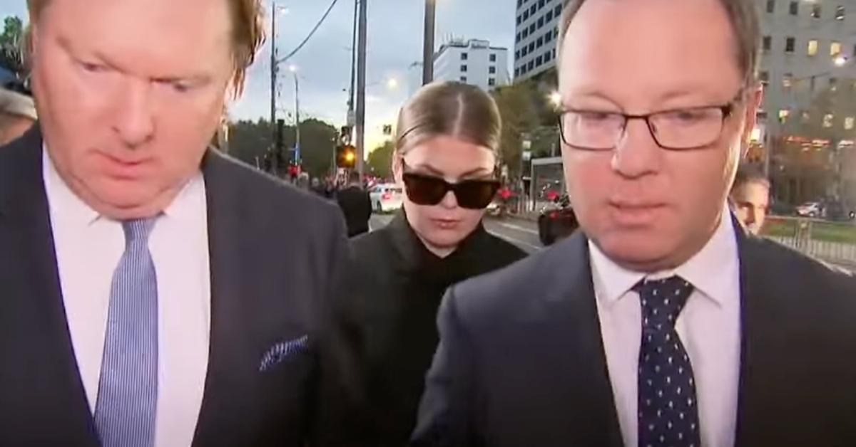 Belle Gibson flanked by her lawyers