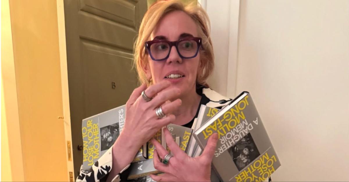 Molly Jong-Fast holds multiple copies of her book, "How to Lose Your Mother."