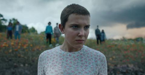 Eleven stands in a field in Stranger Things