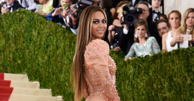 Beyonce looks over her shoulder and smiles at the "Manus x Machina: Fashion In An Age Of Technology" Costume Institute Gala at Metropolitan Museum of Art on May 2, 2016 in New York City.
