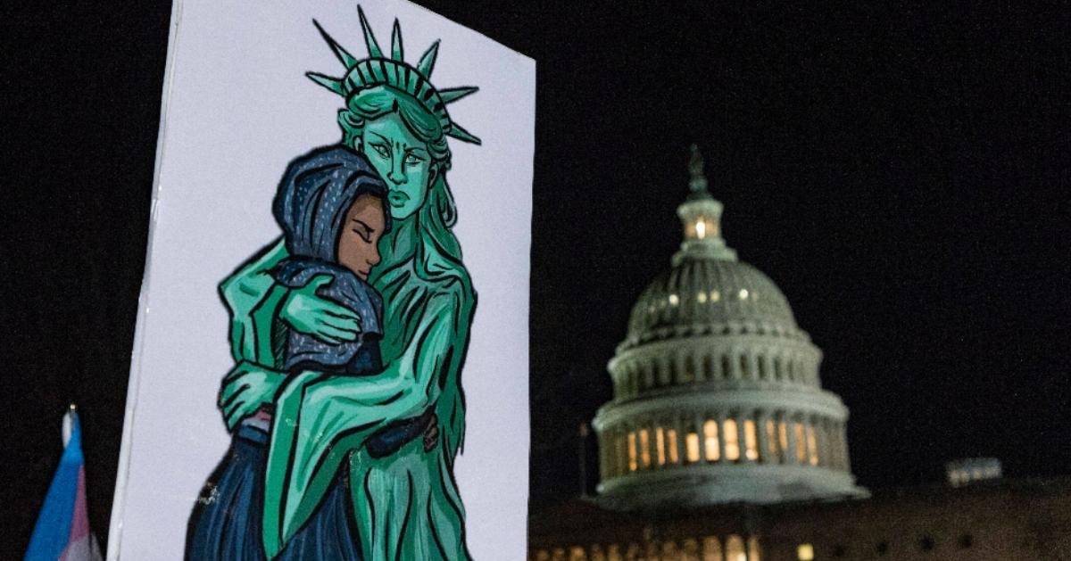 Drawing of the Statue of Liberty hugging an immigrant