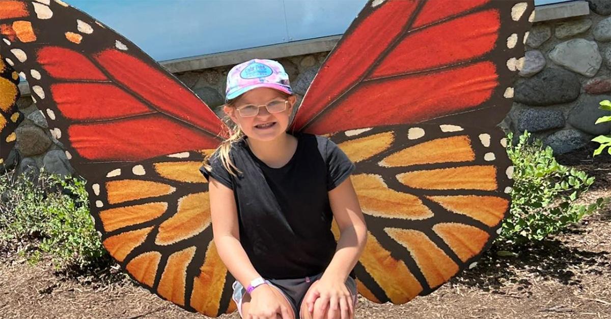 Lucy Nash with butterfly wings behind her. 