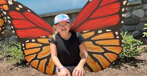 Lucy Nash with butterfly wings behind her.