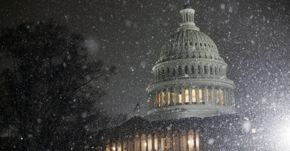 Snow falling on the Capitol Building.