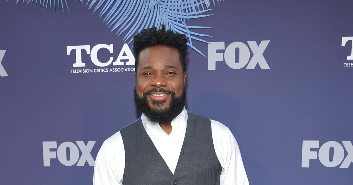 Malcolm-Jamal Warner poses on a red carpet.