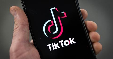 TikTok app is displayed on an Apple iPhone