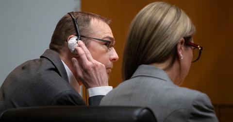 James Crumbley touches his headphones during his trial
