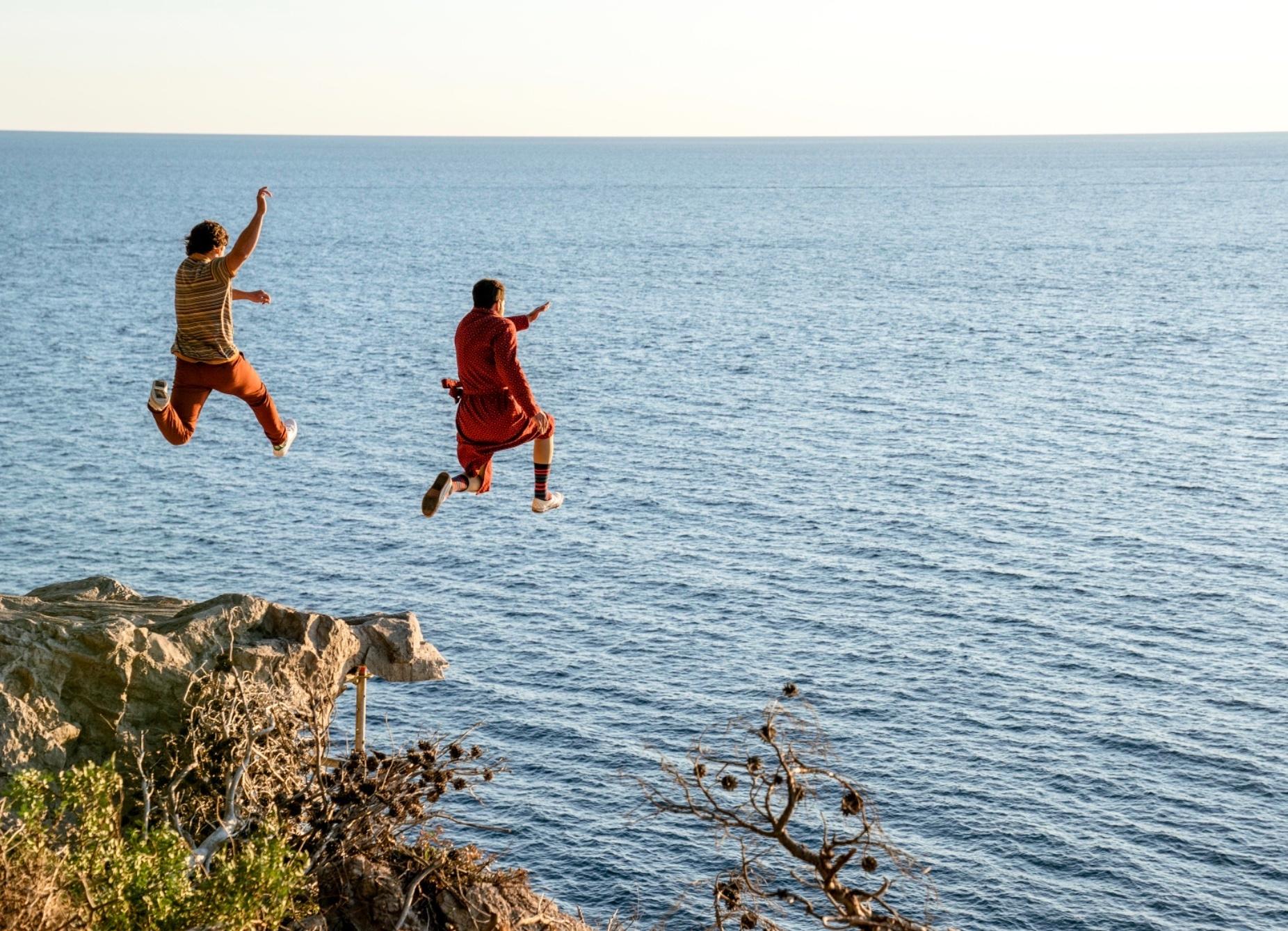 Nicolas Cage and Pedro Pascal jump off a cliff in 'The Unbearable Weight of Massive Talent.'