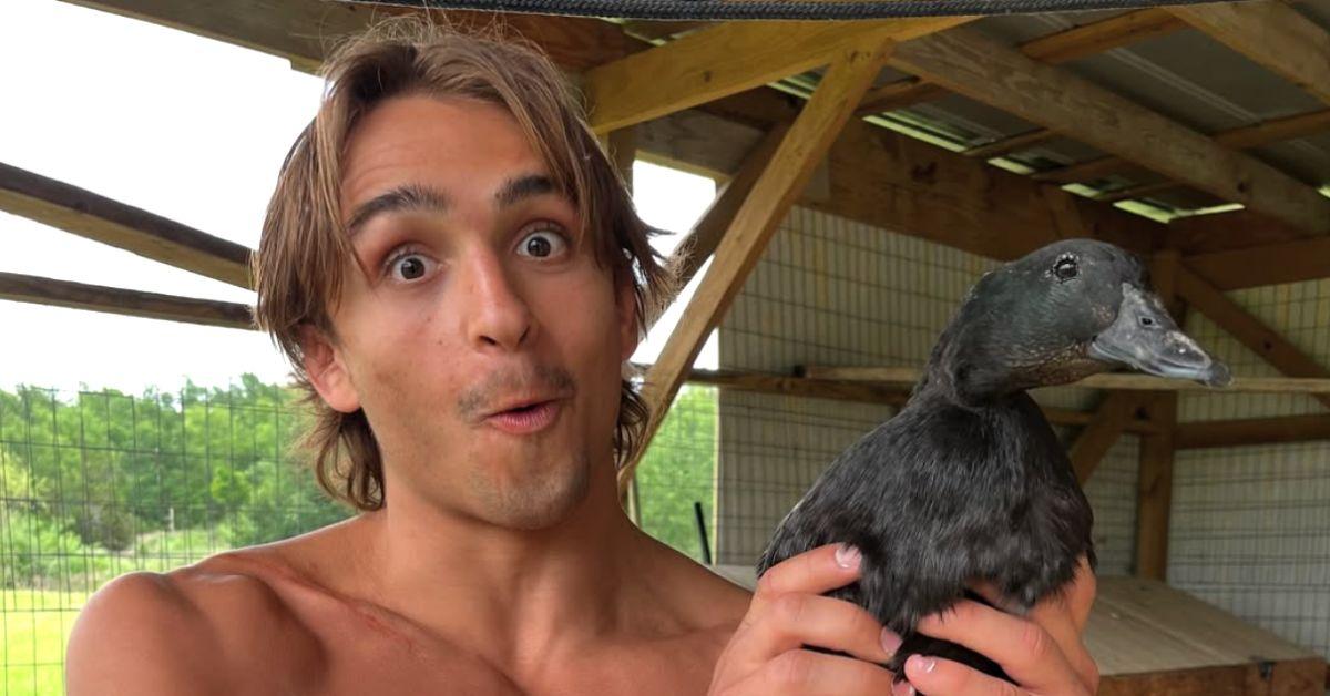 Jay Rod holding a black bird. 