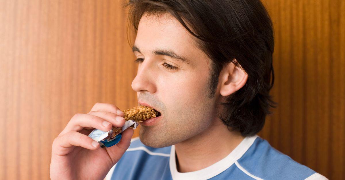 Man eating a protein bar