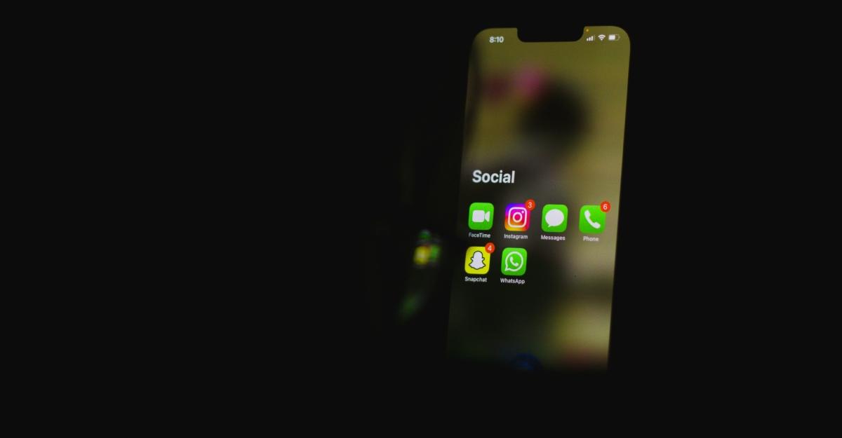 An iPhone displays a group of social media apps against a dark background.