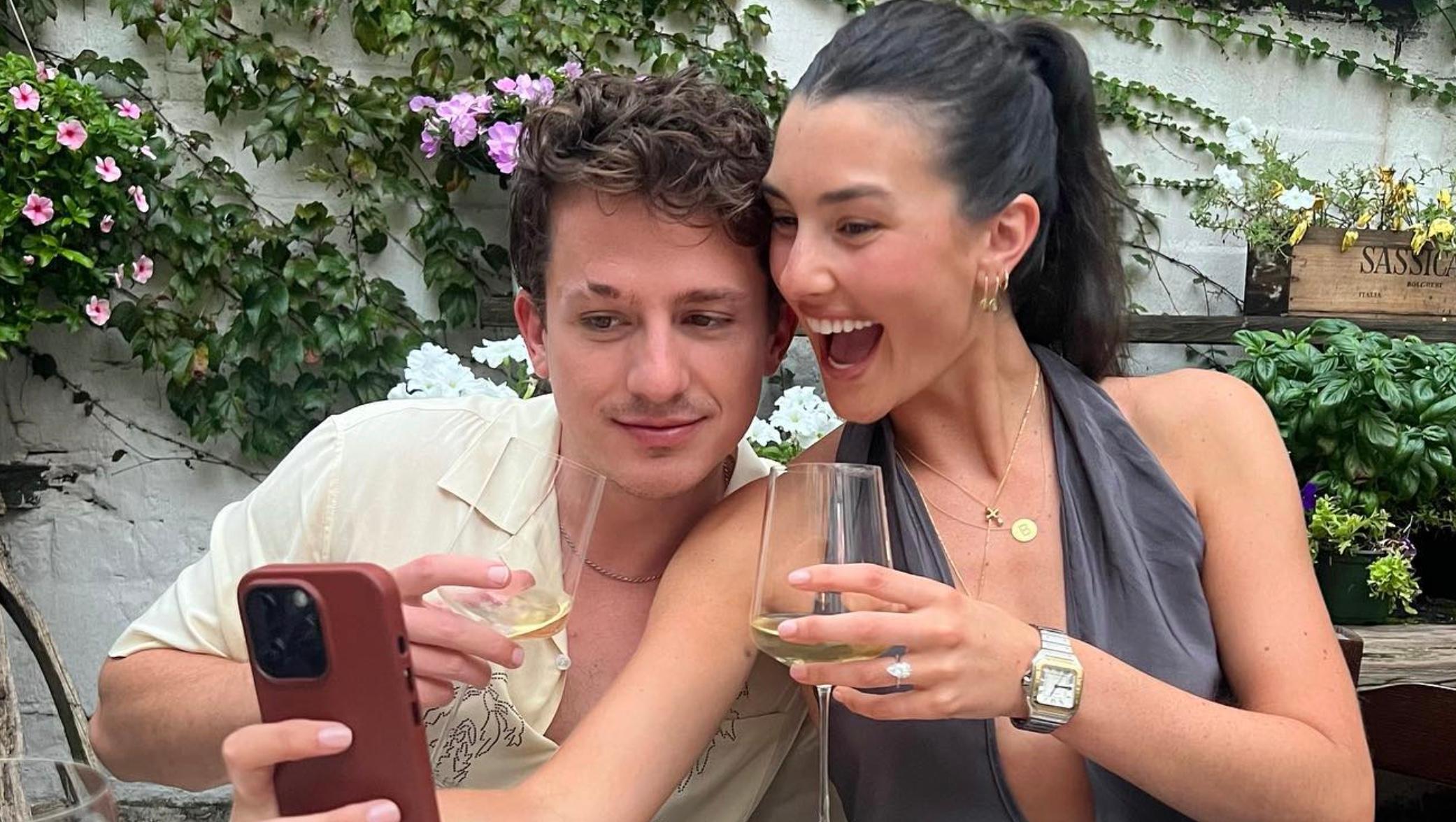 Charlie Puth and Brooke Sansone looking on a cellphone