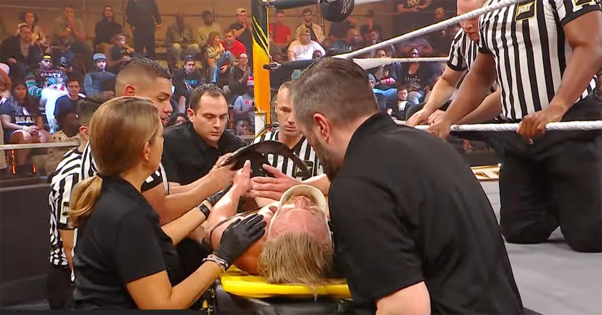 Ilja Dragunov on a stretcher after a wrestling match. 